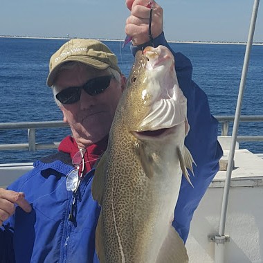 a person holding a fish in the water