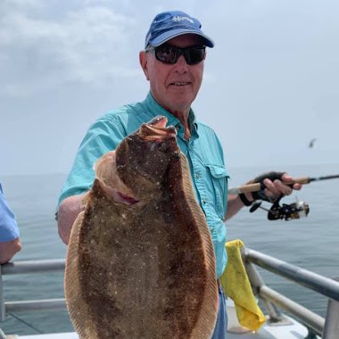 a person holding a fish in the water