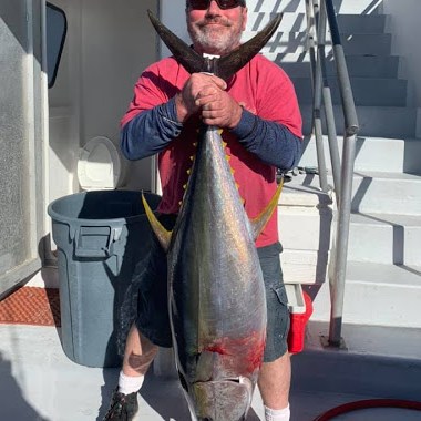 a man holding a fish