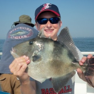 a person holding a fish in the water
