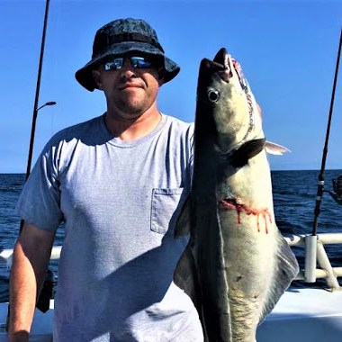 a man holding a fish
