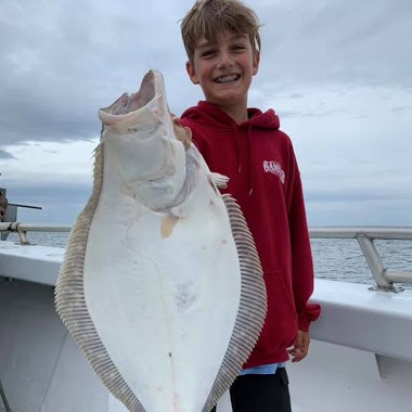 a person holding a fish in the water