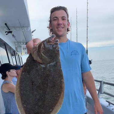 a person holding a fish in the water