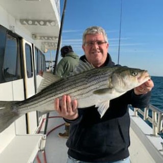 a man holding a fish in the water