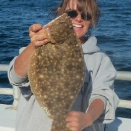 a person holding a fish in the water