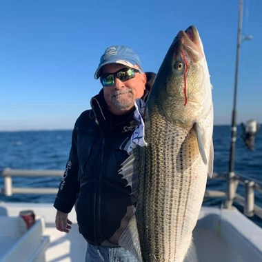 a man holding a fish in the water