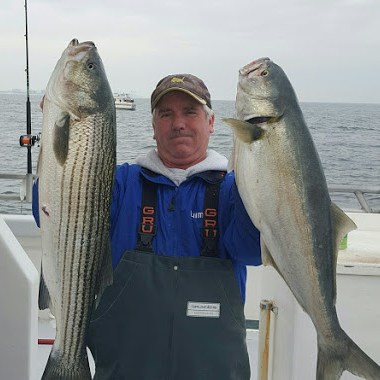 a man holding a fish in the water