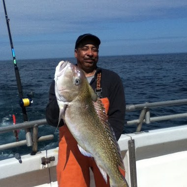 a person holding a fish in the water