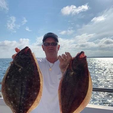 a man holding a fish