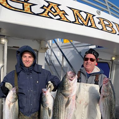 a couple of people that are standing in front of a fish
