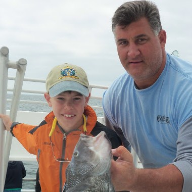 a man holding a fish