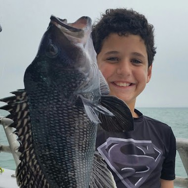 a man holding a fish