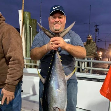 a man holding a fish