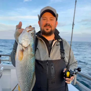 a person holding a fish in the water