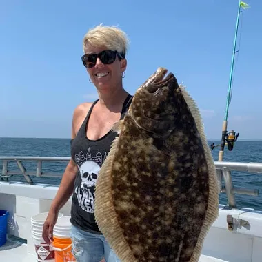 a person holding a fish in the water