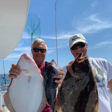 a man holding a fish in the water