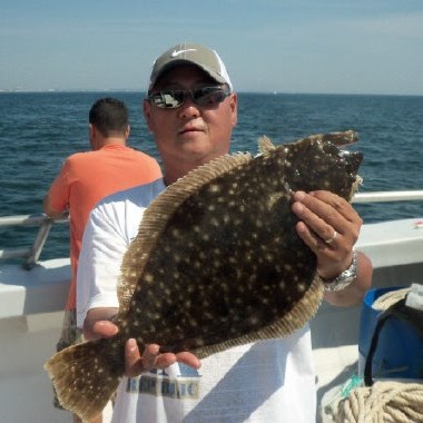 a person holding a fish in the water