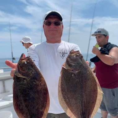 a man holding a fish