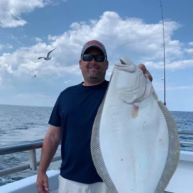 a person holding a fish in the water