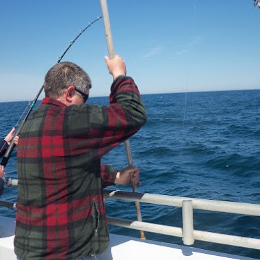 a person standing next to a body of water