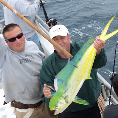 a man holding a fish in the water