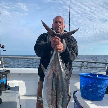 a person holding a fish in the water