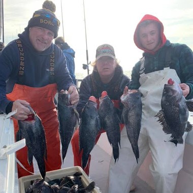a group of people standing in front of a fish