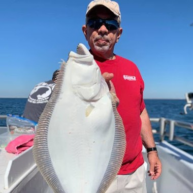 a man holding a fish in the water