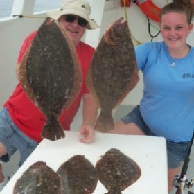 a group of people standing in front of a cake