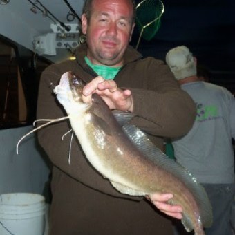 a man holding a fish