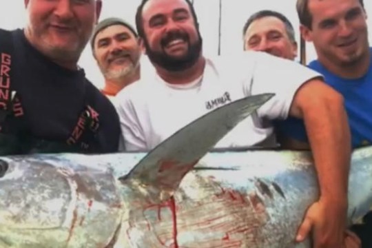 a man holding a fish