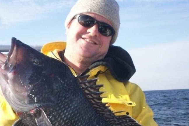a person holding a fish in the water